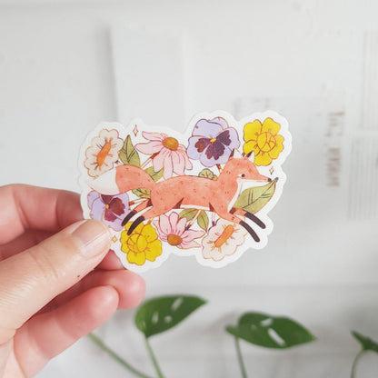 vinyl sticker with a fox jumping through blooming flowers