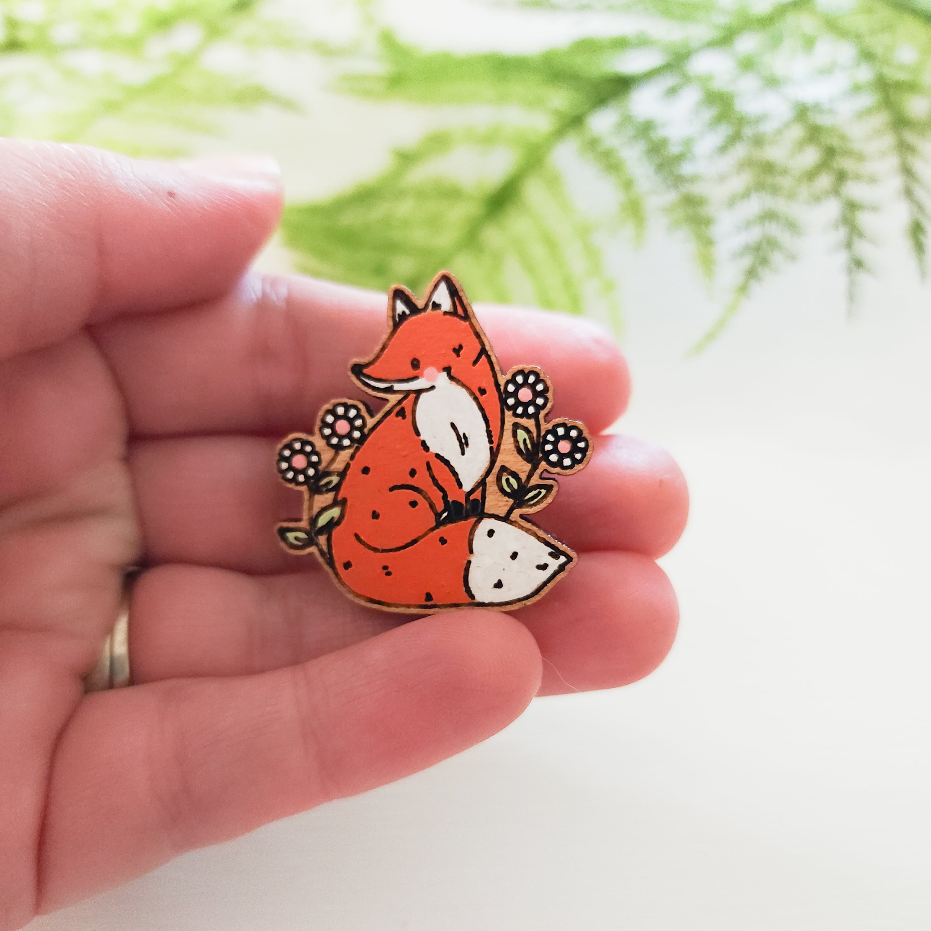 hand holding fox pin