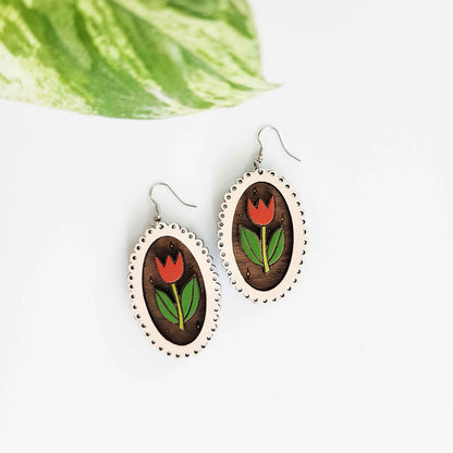 wooden earrings with a pink frame and red and green tulip inside