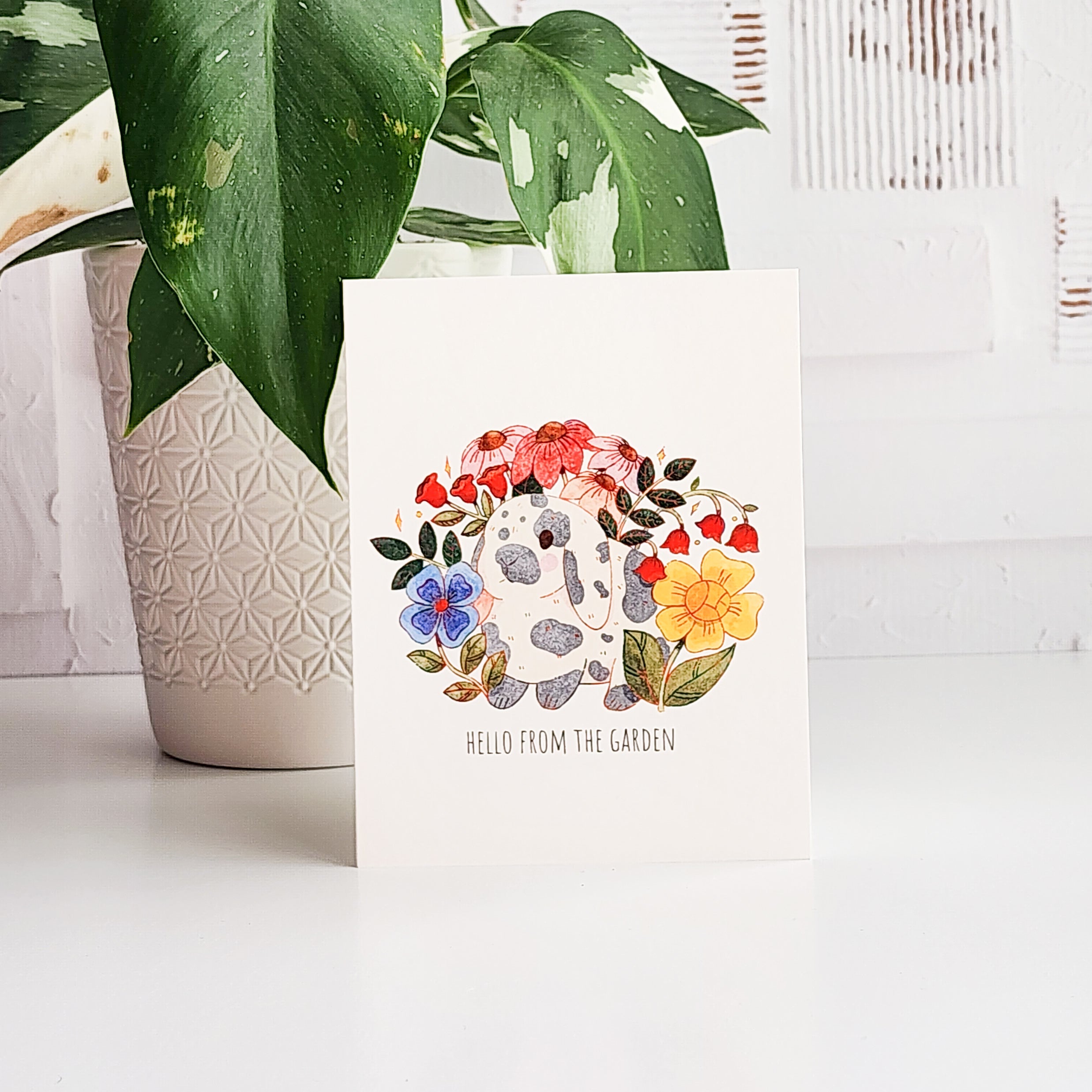 Card with flowers and a rabbit and text &