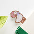 wooden bookmark with the image of a goose holding a bouquet