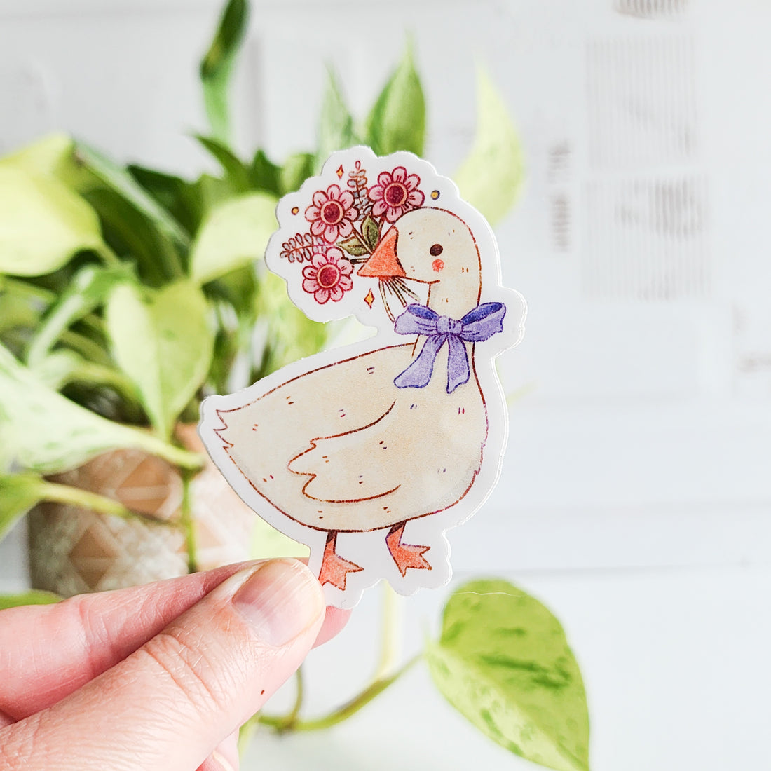 sticker of a goose holding a bouquet of flowers