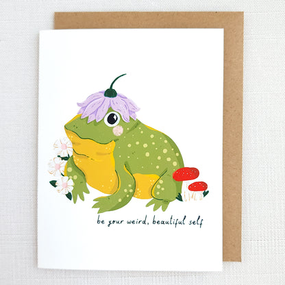 Greeting card with a frog illustration and text be your weird beautiful self on a white background