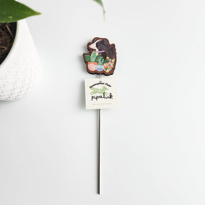dog decorative plant stake with a pipaluk tag on a white background