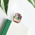dog with houseplants bookmark inside a green and white book on a white background with leaves