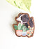 dog and houseplant magnet on a white background with a leaf
