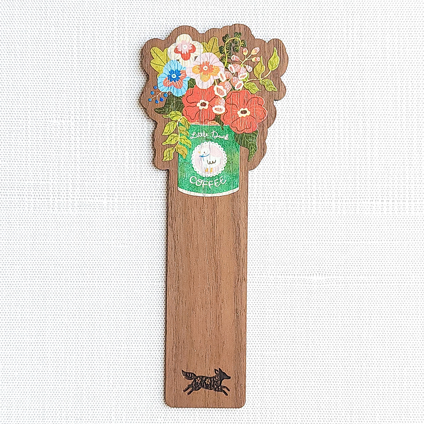 Walnut wood bookmark with a vintage-inspired Little Duck Coffee can filled with cheerful pink, yellow, and blue garden blooms on a neutral background
