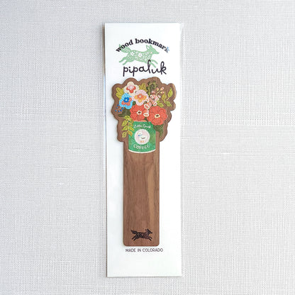 Walnut wood bookmark with a vintage-inspired Little Duck Coffee can filled with cheerful pink, yellow, and blue garden blooms in Pipaluk branded packaging on a neutral background
