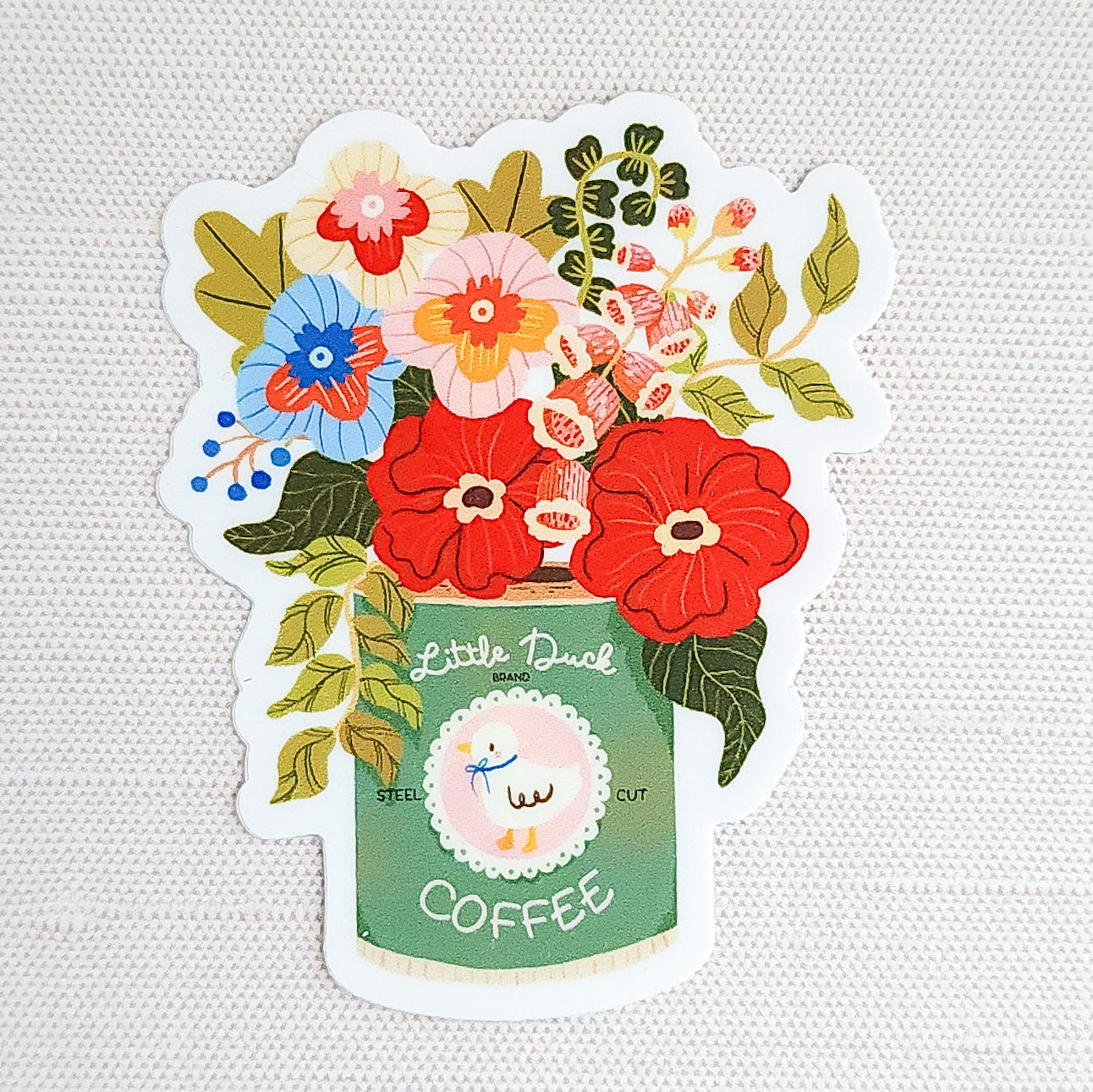 Waterproof vinyl sticker featuring an illustrated Little Duck Coffee can repurposed as a vase, filled with colorful garden flowers on a neutral background