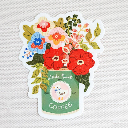 Waterproof vinyl sticker featuring an illustrated Little Duck Coffee can repurposed as a vase, filled with colorful garden flowers on a neutral background