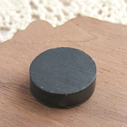 ceramic magnet on a wooden magnet background