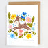 Greeting card with a deer illustration surrounded by flowers on a white background
