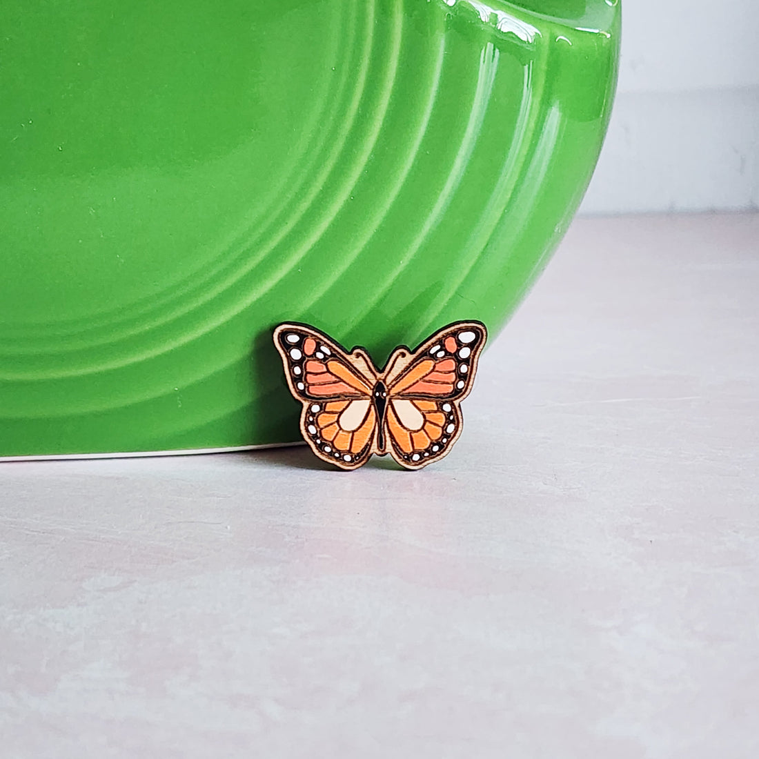 orange and black monarch butterfly pin
