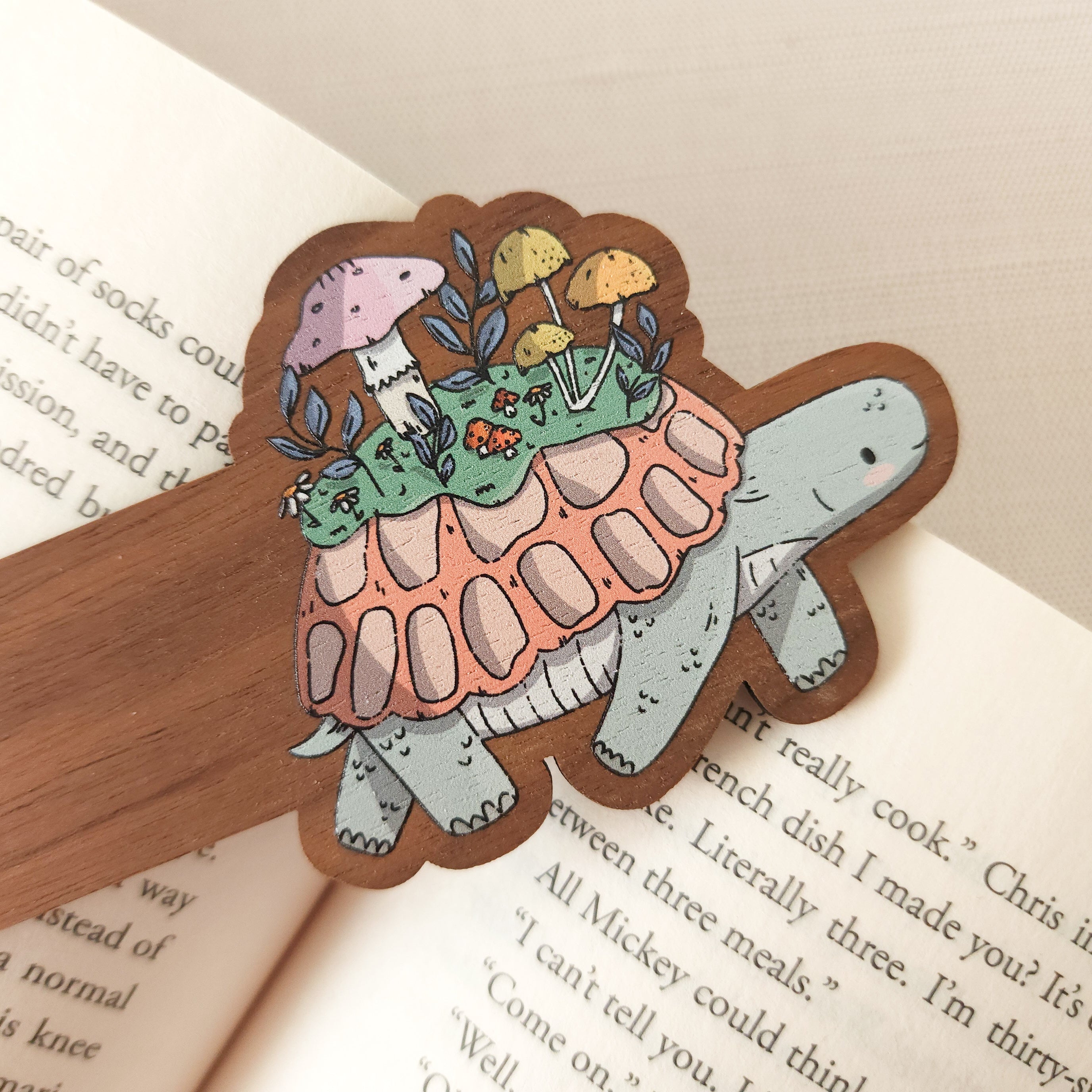 bookmark with an illustration of a turtle sitting on an open book