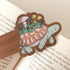 bookmark with an illustration of a turtle sitting on an open book