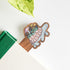Decorative wooden bookmark with a colorful design of a turtle on a book