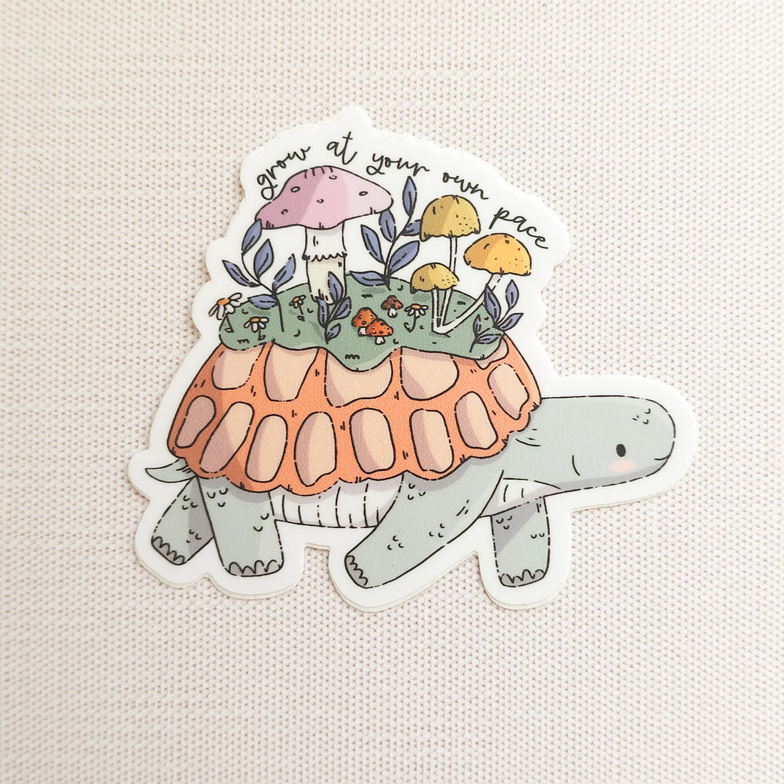 Sticker of a turtle with a mushroom garden on its shell on a linen background