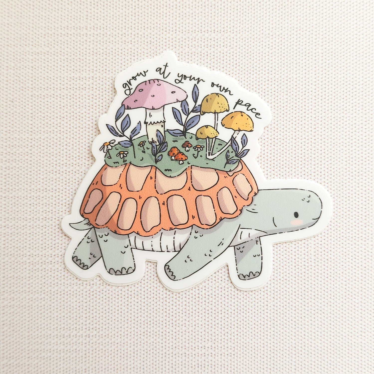Sticker of a turtle with a mushroom garden on its shell on a linen background
