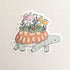 Sticker of a turtle with a mushroom garden on its shell on a linen background