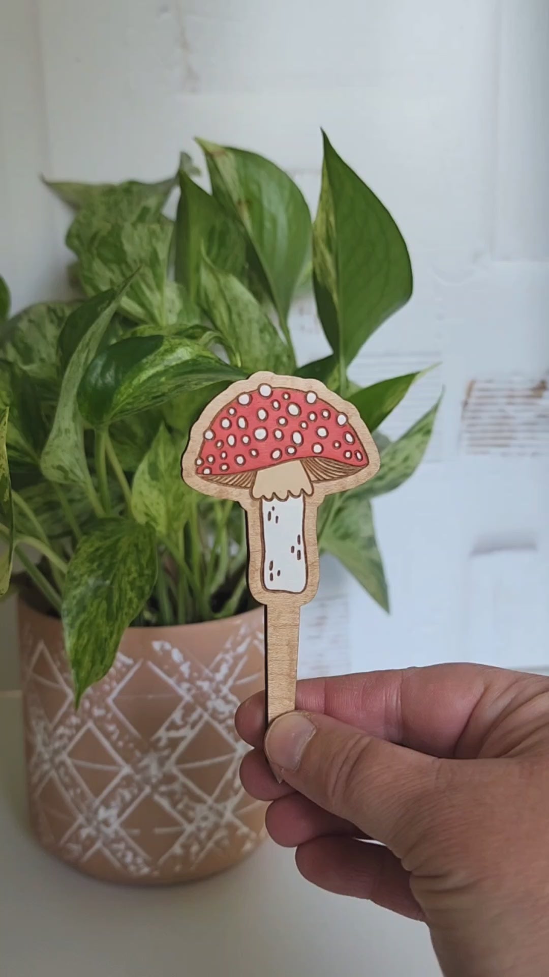 mushroom plant pick alternating between front and back of design and then placed inside of a potted plant
