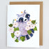 Card with a raccoon illustration surrounded by flowers and leaves on a white background.