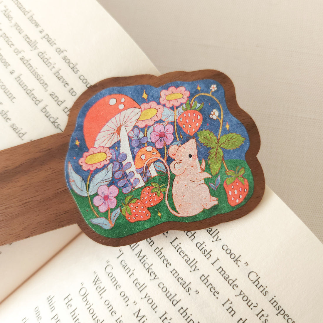 wooden bookmark with an illustration of a mouse picking strawberries on an open book