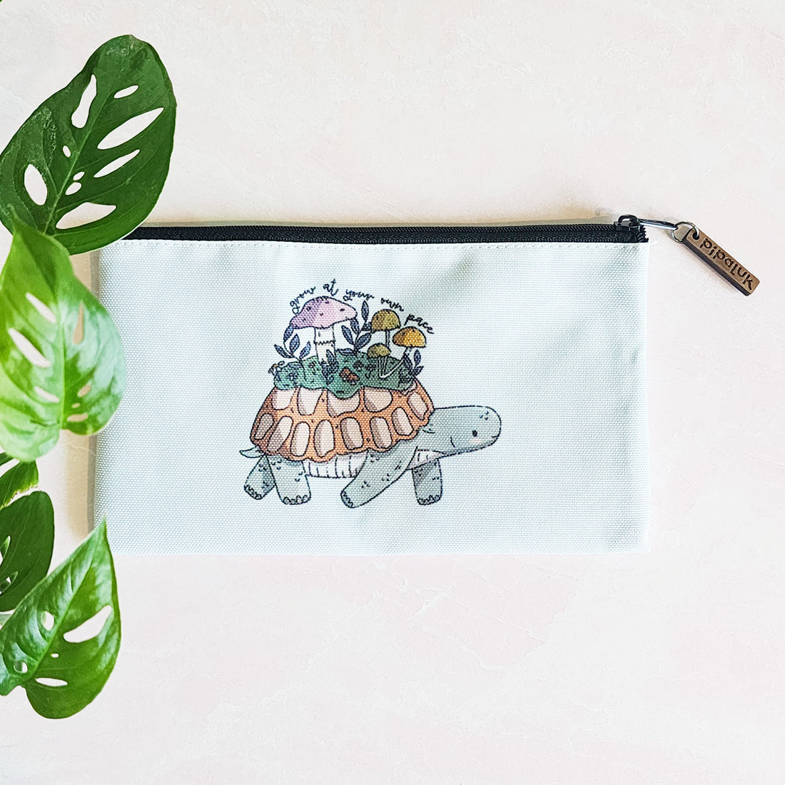 blue zipper pouch with a turtle and the words grow at your own pace