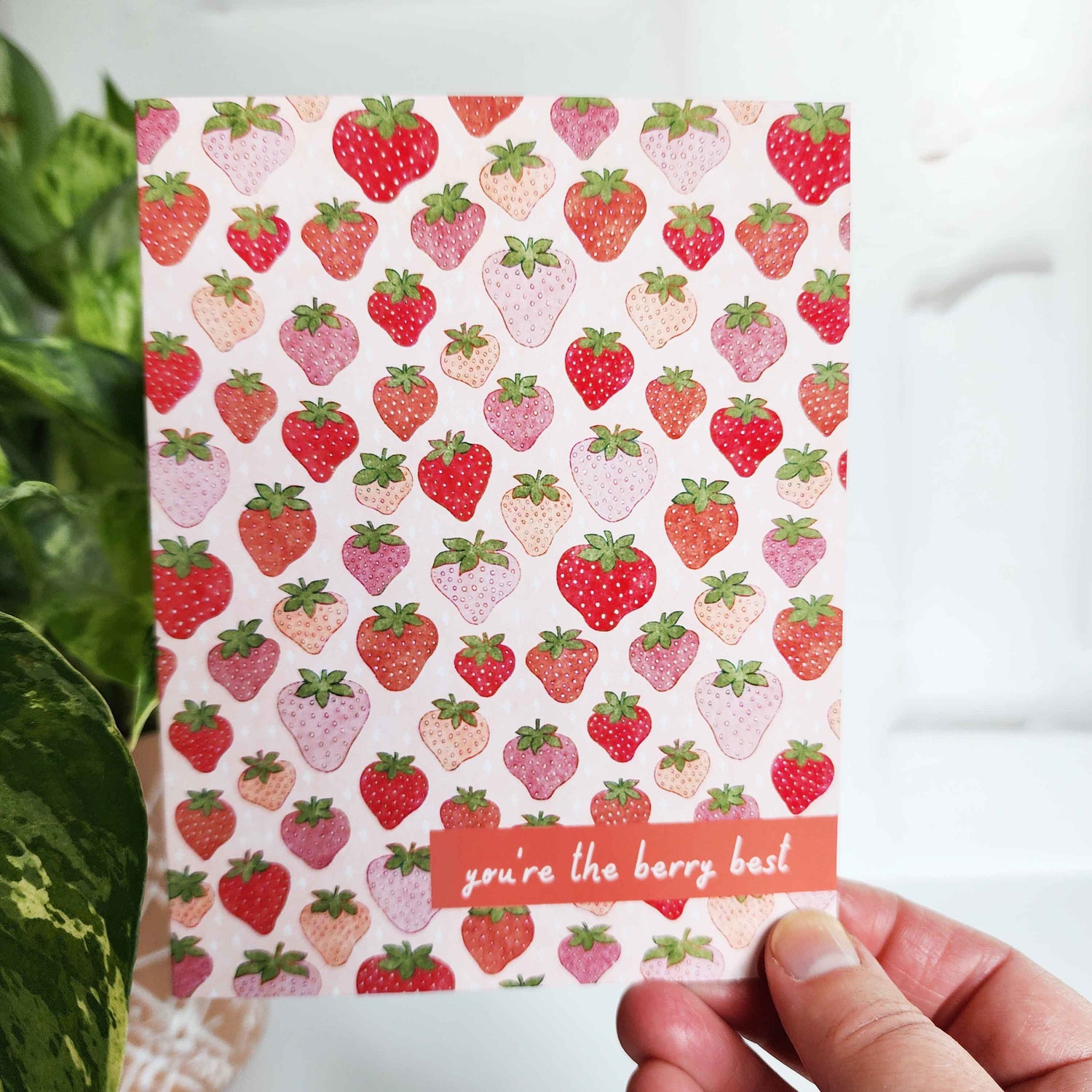 card with a strawberry pattern and the words you&