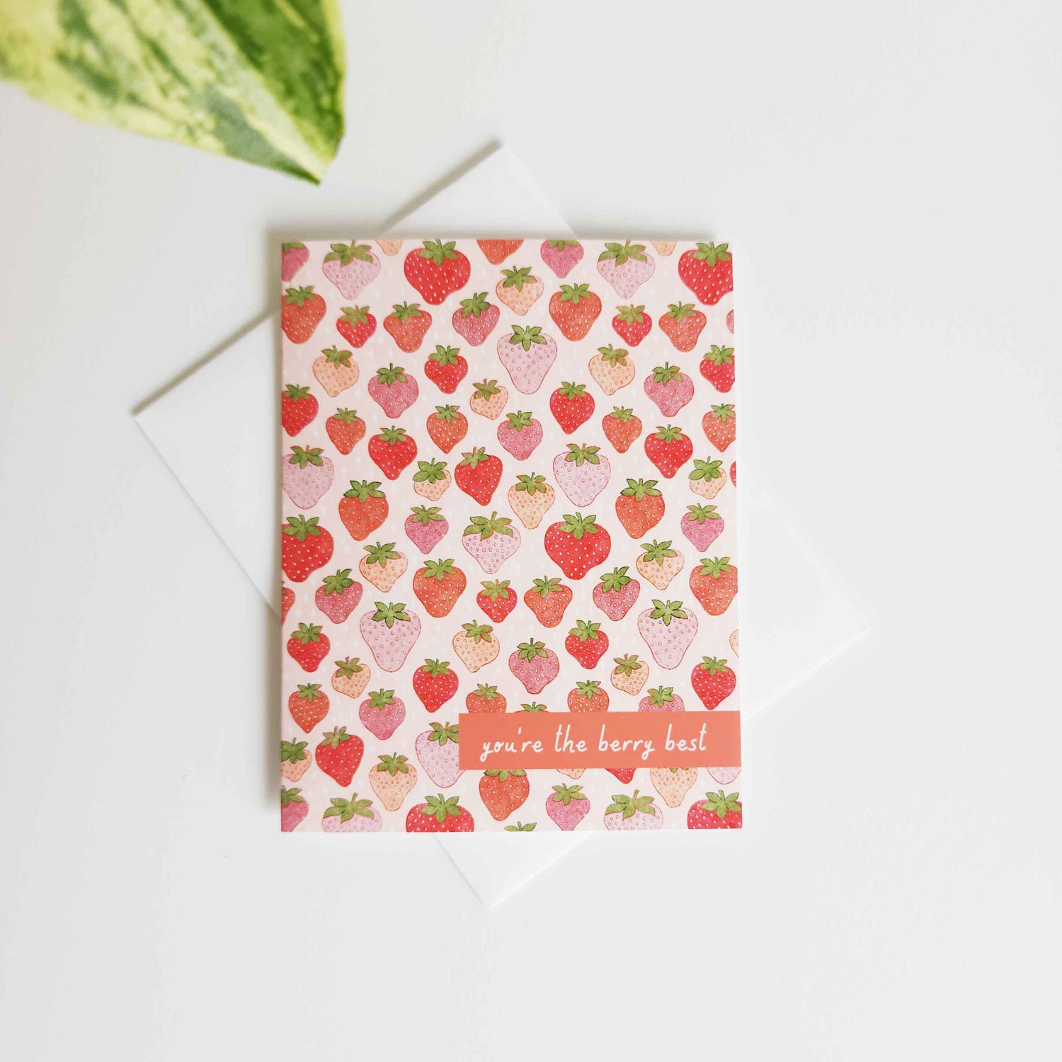 card with a strawberry pattern and the words you&