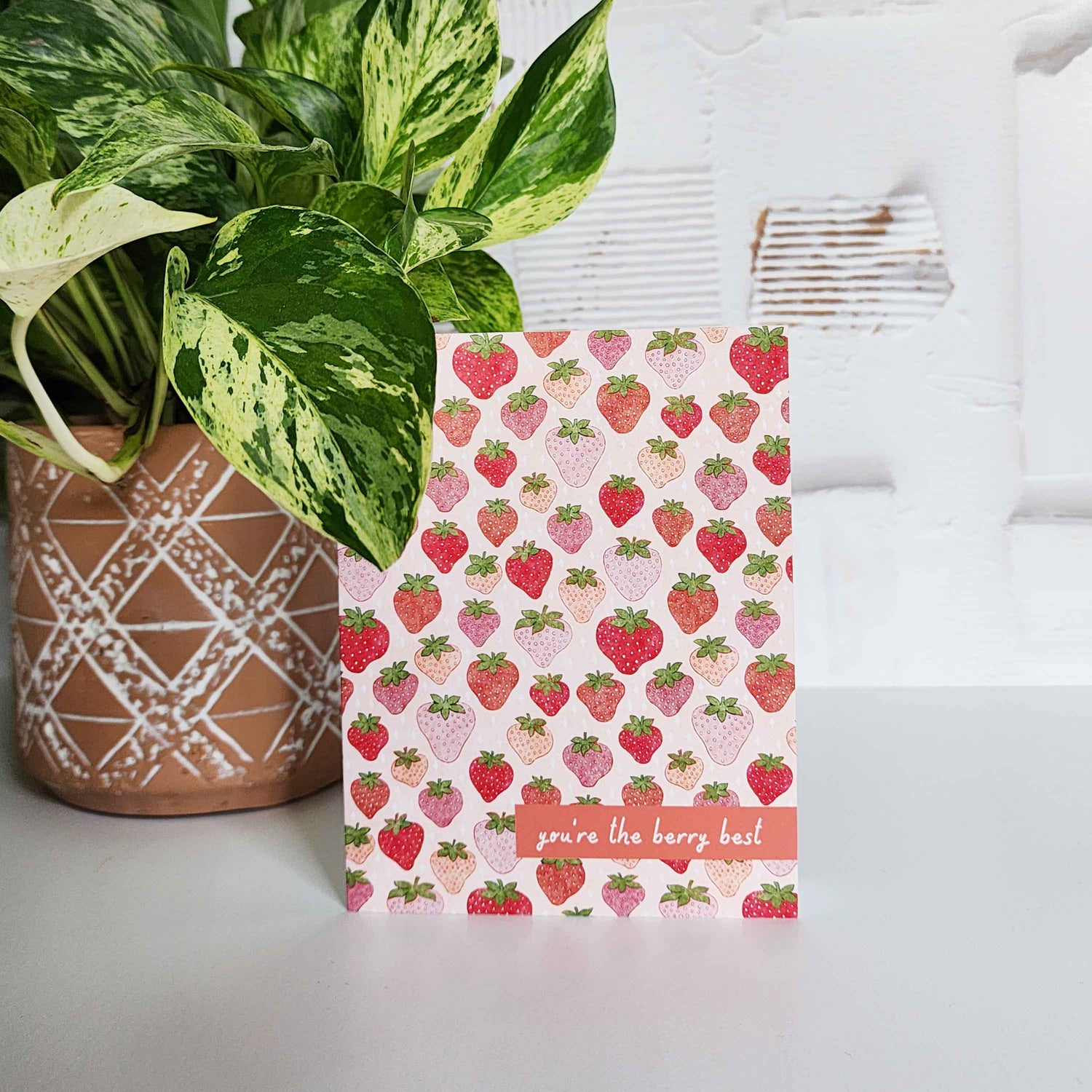 card with a strawberry pattern and the words you&