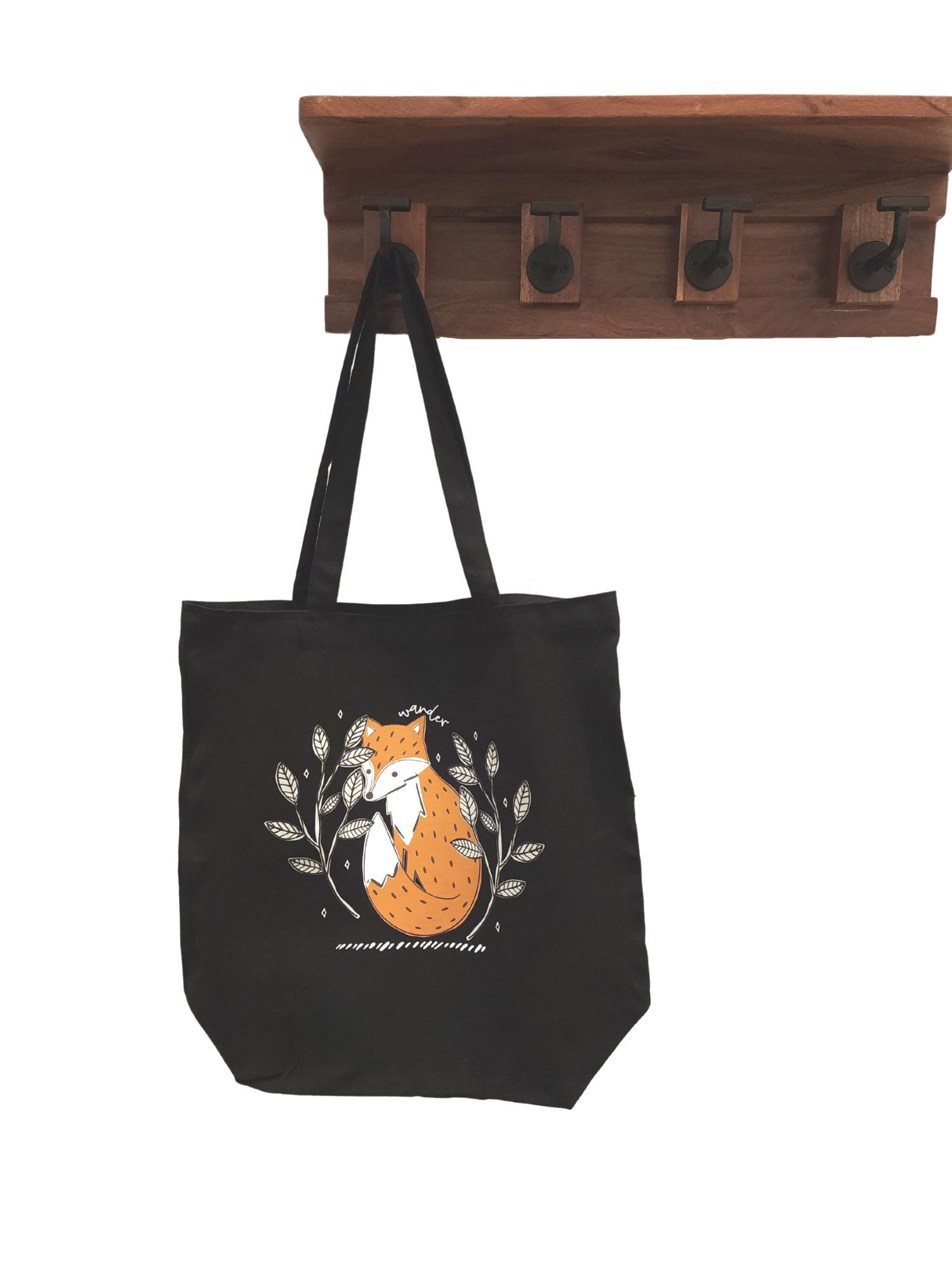 black tote bag with orange fox surrounded by branches and stars with the words wander along the top